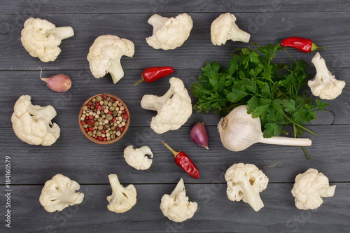 Wallpaper Mural Fresh cauliflower cut into small pieces with garlic and chili peppers on black wooden background Torontodigital.ca