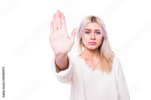 Lady making stop gesture with her palm, isolated on white background