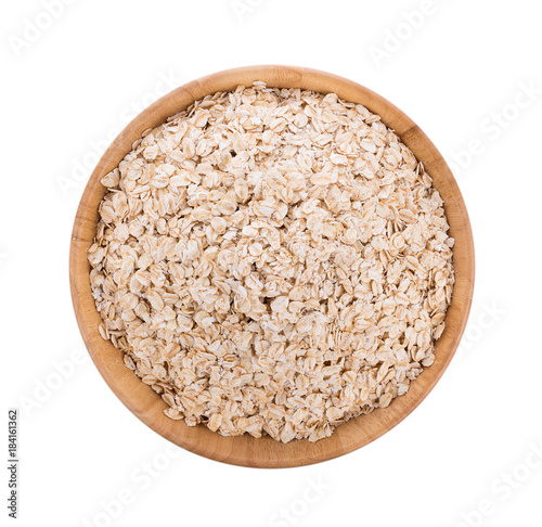 Oat flakes pile in bowl on white background