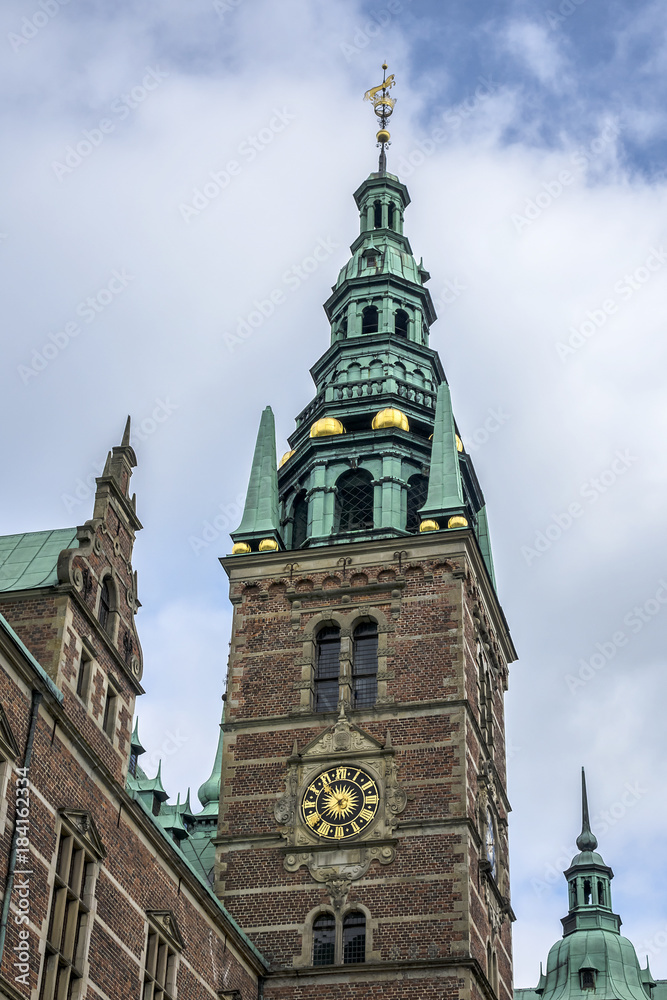 Fototapeta premium Frederiksborg Castle (Frederiksborg Slot, XVII century) - palace in Hillerod, Denmark. It was built as royal residence for King Christian IV of Denmark-Norway, now History Museum. Belfry tower.