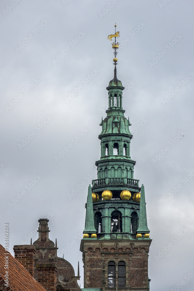 Fototapeta premium Frederiksborg Castle (Frederiksborg Slot, XVII century) - palace in Hillerod, Denmark. It was built as royal residence for King Christian IV of Denmark-Norway, now History Museum. Belfry tower.