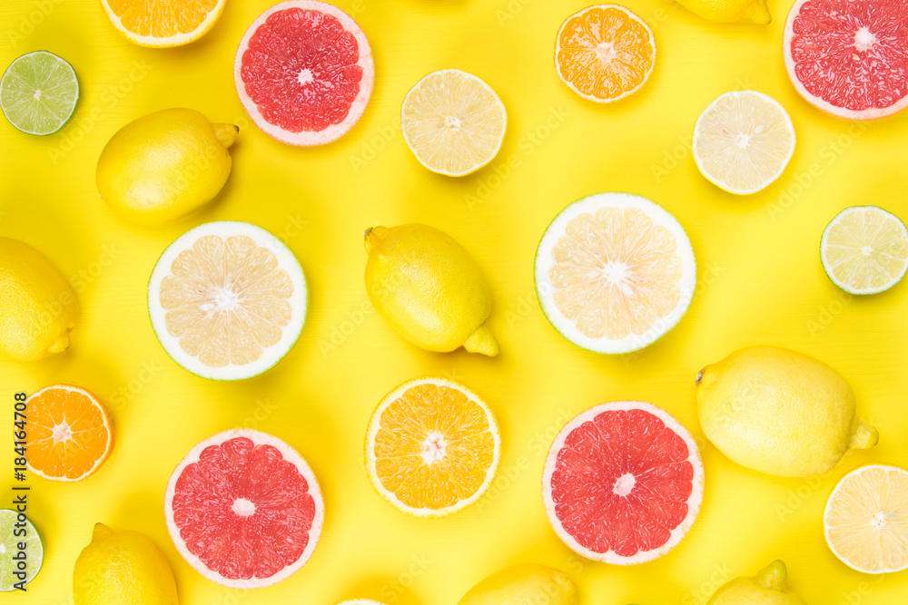 on a yellow wooden table lie cut lemons and lime and greyfruit together on a yellow wooden table lie cut lemons and lime and greyfruit together