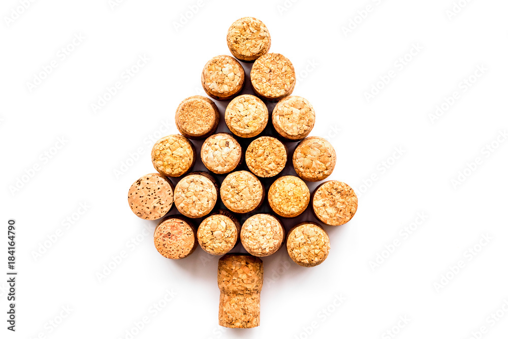 Corks of wine bottles in shape of new year spruce on white background top view copyspace Corks of wine bottles in shape of new year spruce on white background top view copyspace