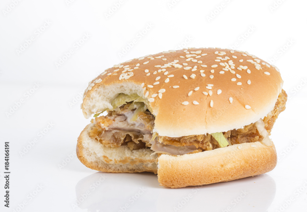Tasty hamburger missing a bite on a white background. Tasty hamburger missing a bite on a white background.