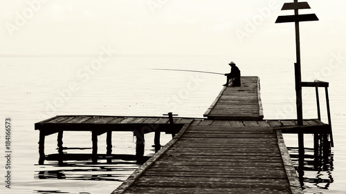 fisherman on the old bridge. photo