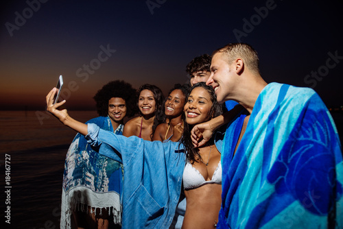 Group of friends taking night bath in the ocean