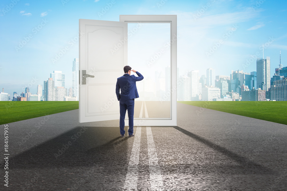 Businessman in front of door in business opportunities concept Businessman in front of door in business opportunities concept