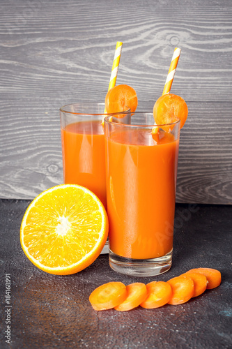 Carrot and orange smoothie on gray background