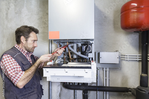 Принти на полотні plumber repairing a condensing boiler