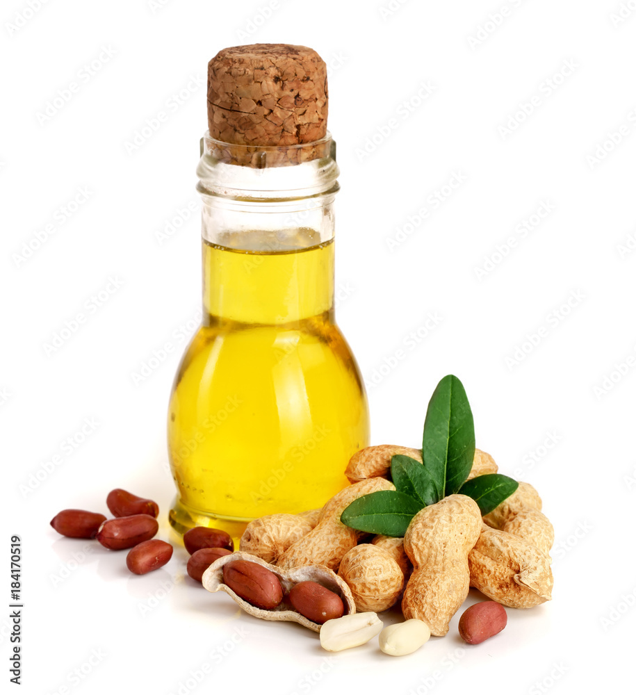peanut oil in a glass bottle with peanuts peanut oil in a glass bottle with peanuts