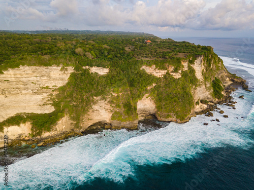 Aerial view of ocean rocky cliff near Uluwatu temple. Scenic landscape of fantastic view from drone. Bali, Indonesia.