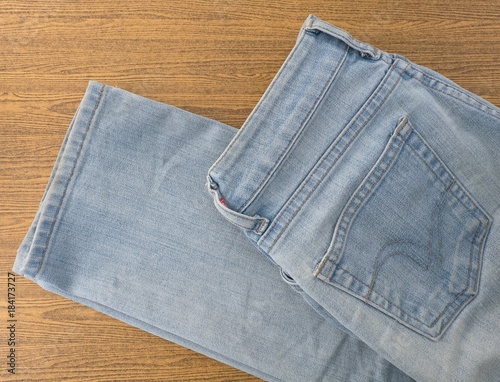 Blue Denim Jean on A Wooden Table photo