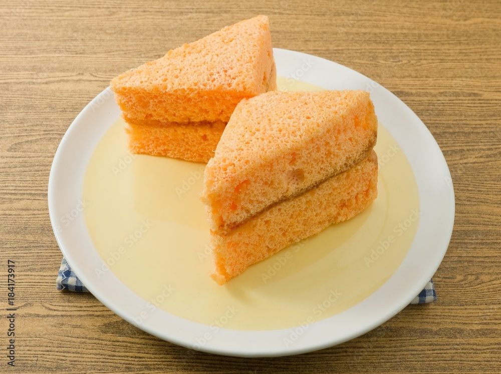 Two Triangle Orange Chiffon Cake on A Dish Two Triangle Orange Chiffon Cake on A Dish