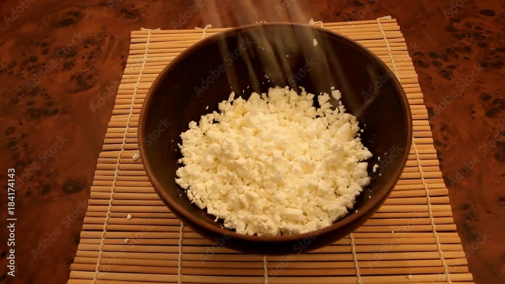 putting the curd into a deep brown ceramic bowl putting the curd into a deep brown ceramic bowl