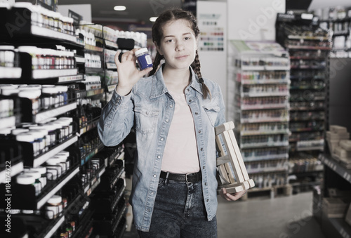 Girl choosing color paint