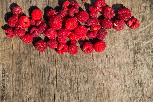 Raspberries on rustic wooden background. Top view with copy space
