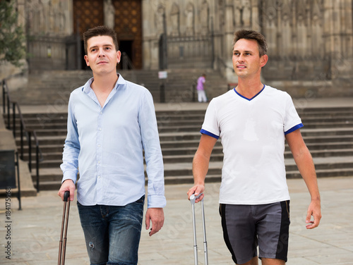 Photography Male couples with travel bags walking the city