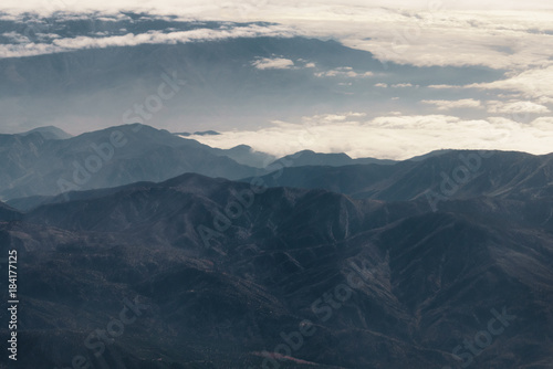 Fototapeta Naklejka Na Ścianę i Meble -  aerial shot from plane flying above the california mountains in daytime