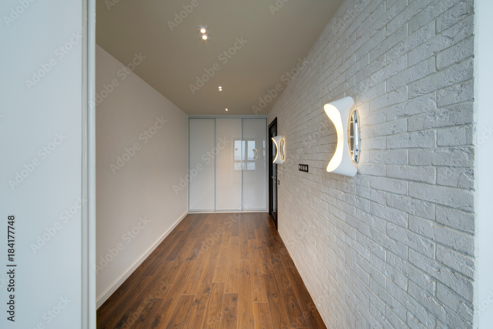 The white room with a dark wooden floor and a white brick wall The white room with a dark wooden floor and a white brick wall
