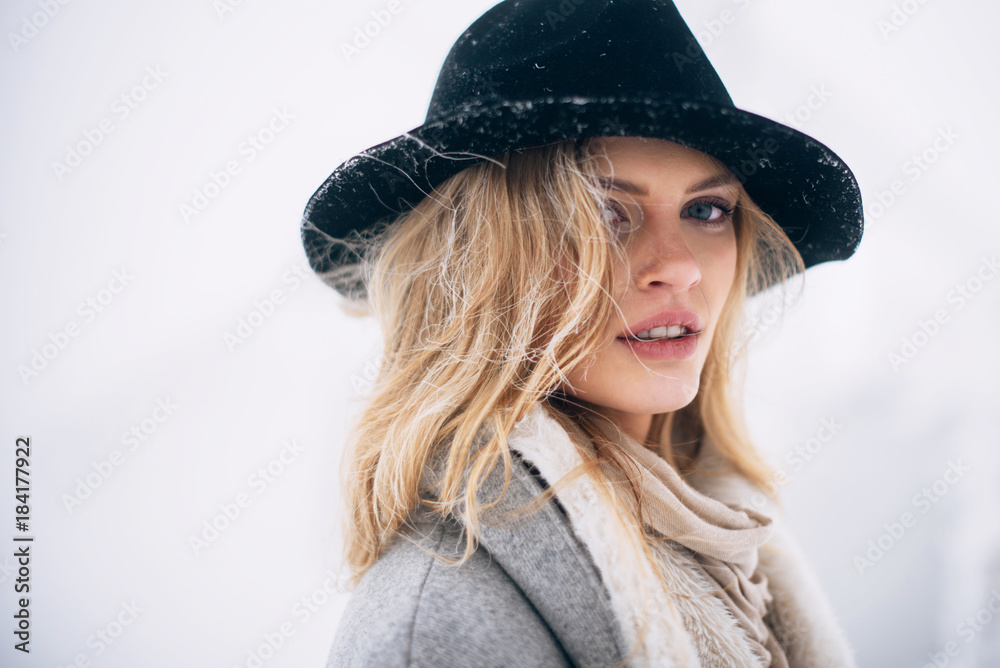 Portrait of beautiful smiling blonde woman in hat and grey coat Portrait of beautiful smiling blonde woman in hat and grey coat