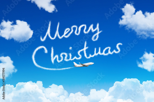 Happy Merry Christmas concept. Drawing by airplane vapor contrail in sky. © aapsky