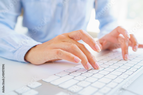 Female woman office worker typing on the keyboard