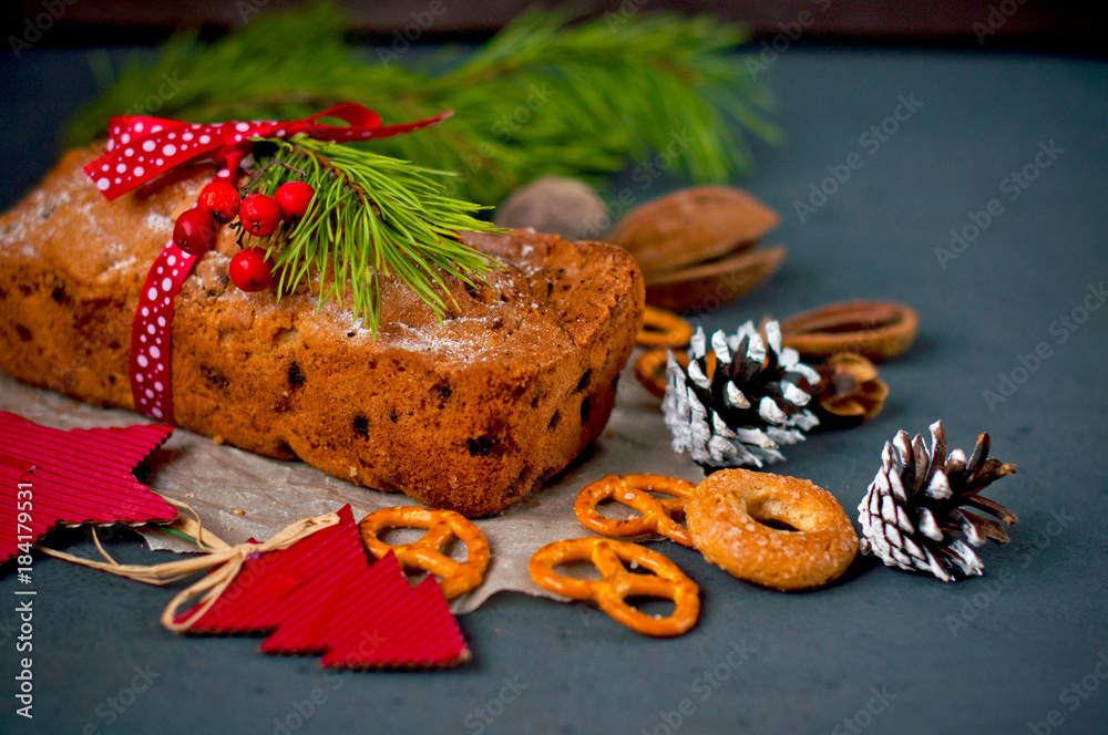 Christmas cake, sweet dessert and New Year decor on a dark background.