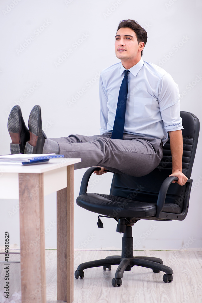 Businessman doing sports in office during break Businessman doing sports in office during break