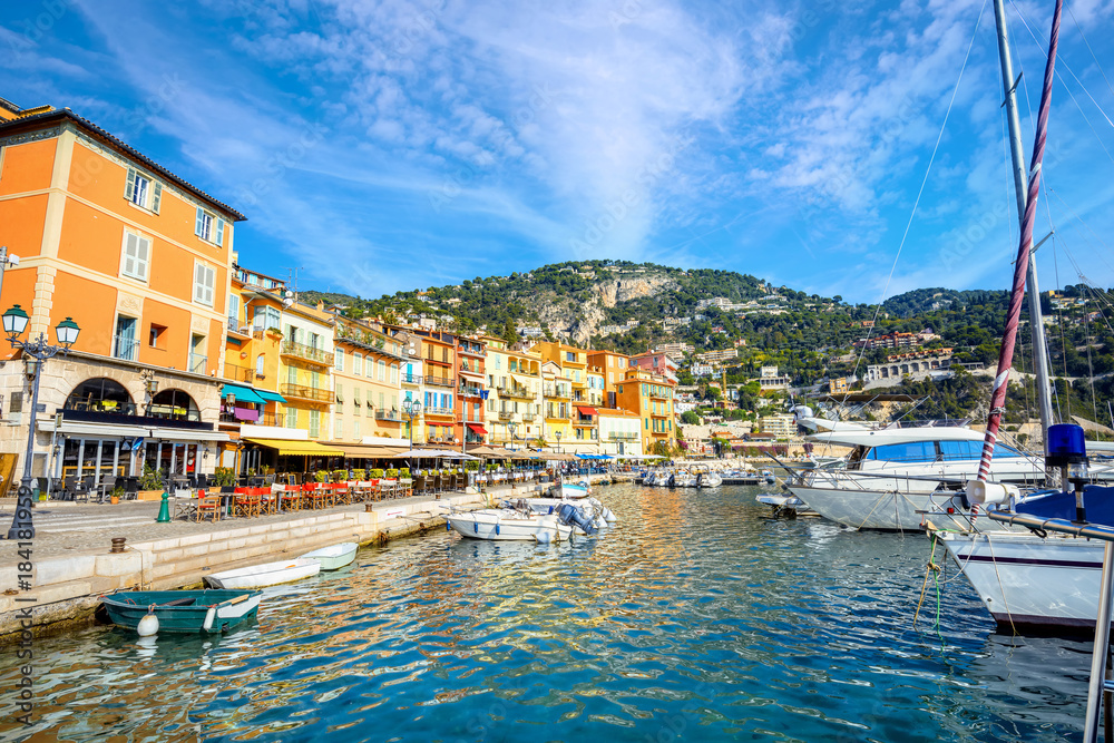 Cityscape with yachts and colorful houses in village of Villefranche-sur-Mer. Cote d'Azur, France