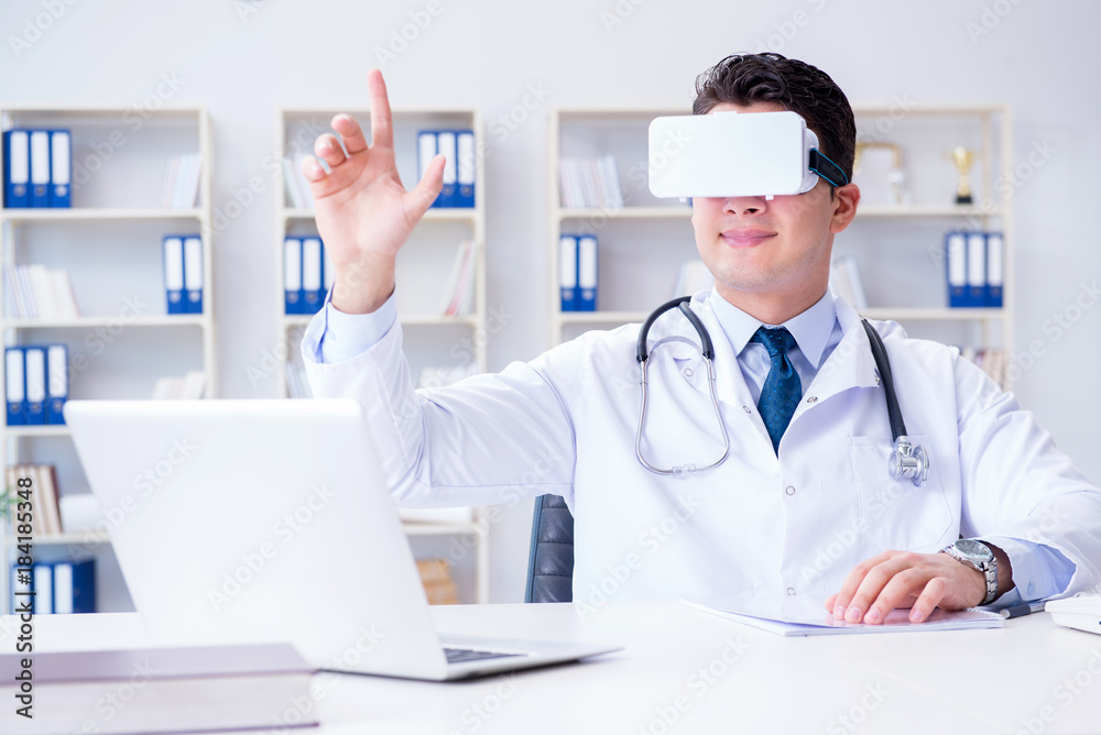 Young doctor with vr virtual reality headset working in the offi Young doctor with vr virtual reality headset working in the offi