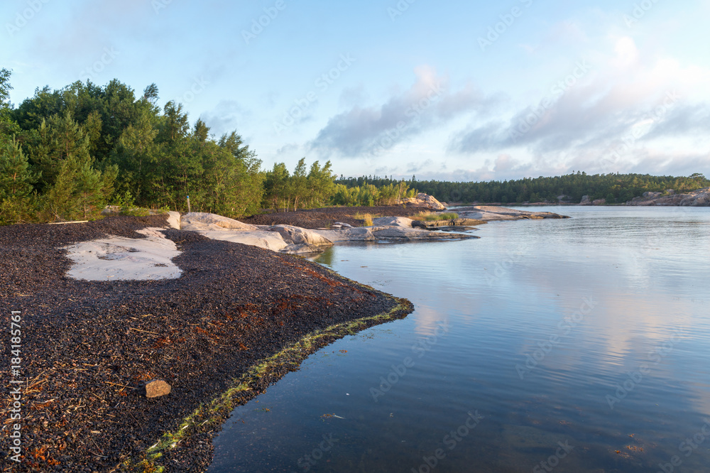 Beautiful and calm landscape in Finnish island. Calm beach at sunrise time. Beautiful and calm landscape in Finnish island. Calm beach at sunrise time.