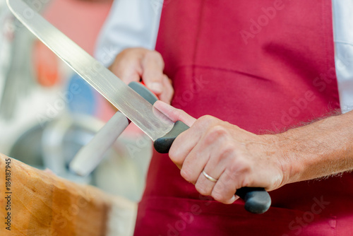 man sharpening a knife