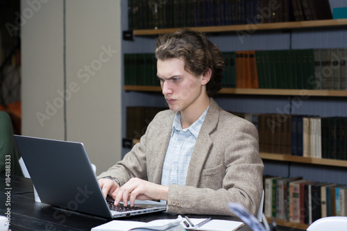 Young freelancer looking in the laptop photo