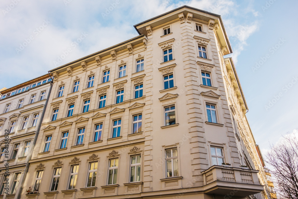 Fototapeta premium yellow corner building at prenzlauer berg in low angle view