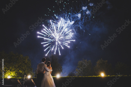 Couple watching fireworks at wedding