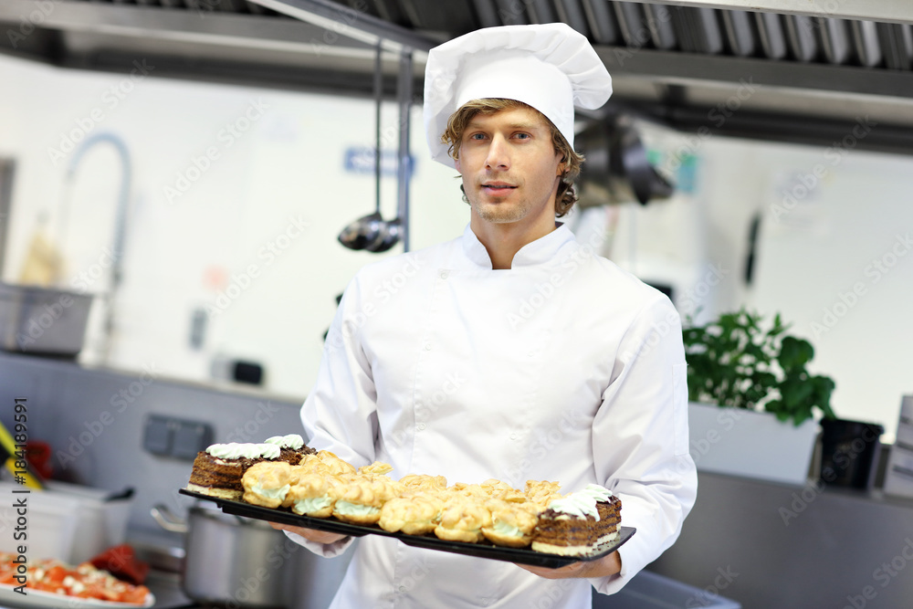 Busy chef at work in the restaurant kitchen Busy chef at work in the restaurant kitchen