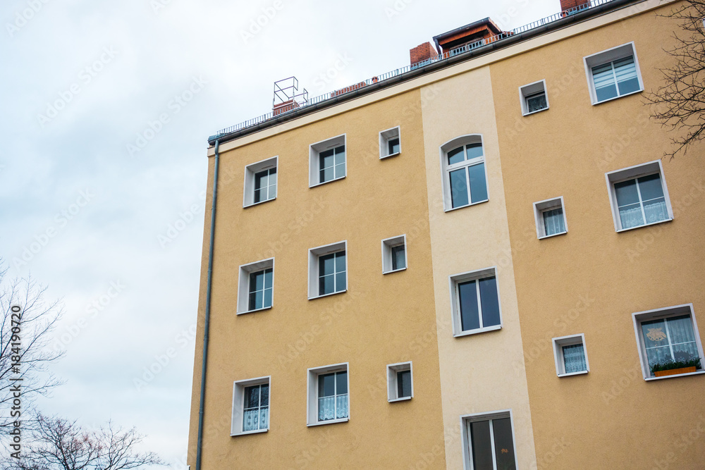 orange apartment building on a cloudy day orange apartment building on a cloudy day