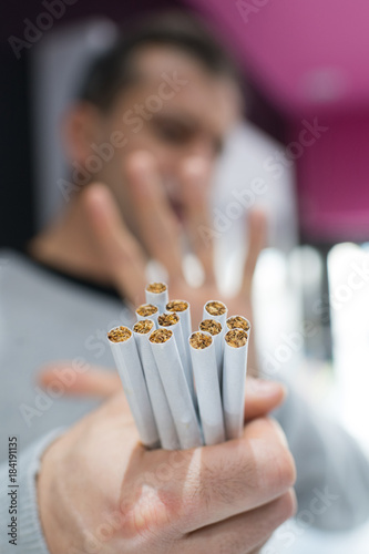 cigarettes in mans hand