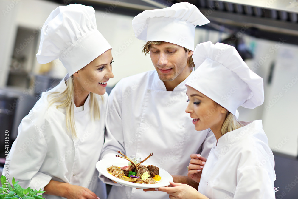 Busy chefs at work in the restaurant kitchen