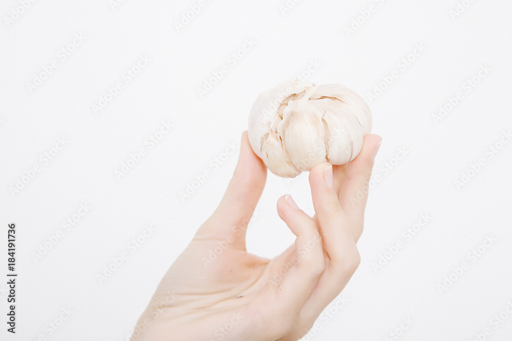 The girl holds the garlic in her arms. Garlic in the hands. The girl holds the garlic in her arms. Garlic in the hands.
