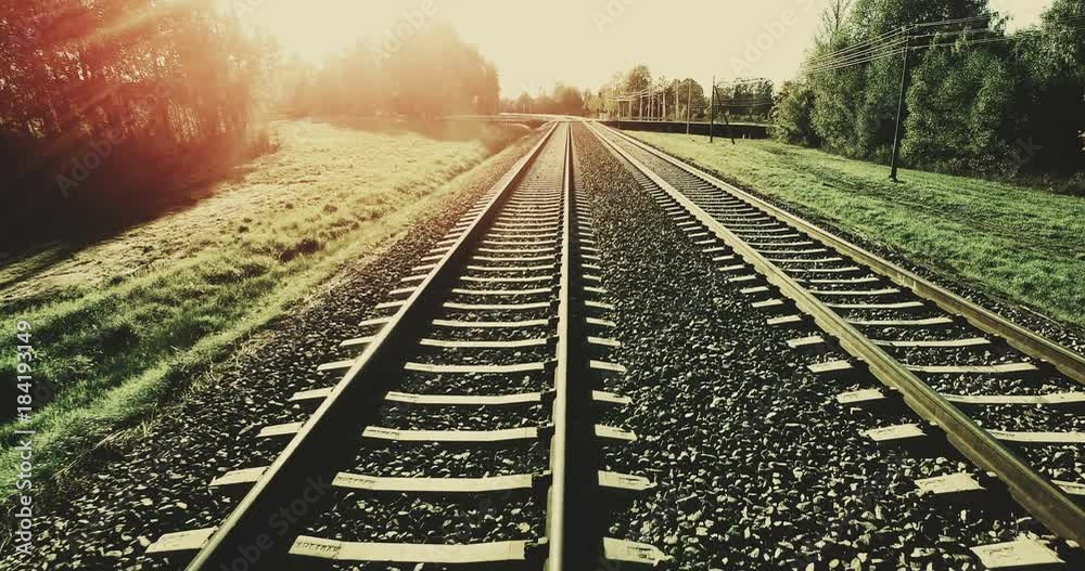 AERIAL. Camera flight from train tracks to the high summer sunset sky (filter added). 4k