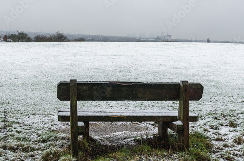 A bench in a snowy park