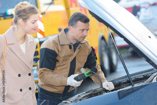 auto mechanic and female customer in auto repair shop