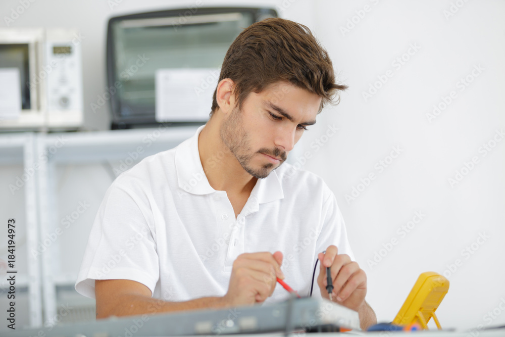 handsome electrician testing induction hobs handsome electrician testing induction hobs