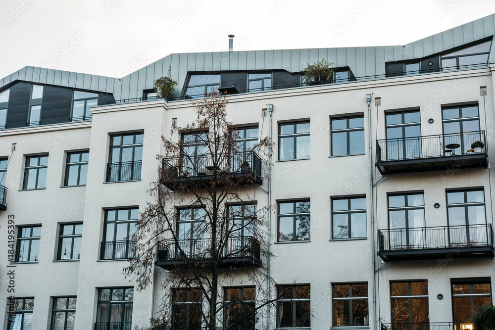 Fototapeta premium white modern apartment house with steel balcony