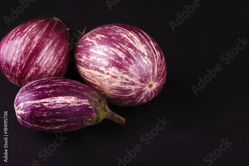 three striped ripe eggplants