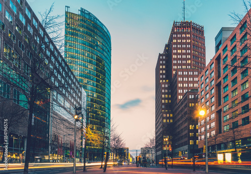 street at potsdamer platz in the night with lens flares from driving cars photo