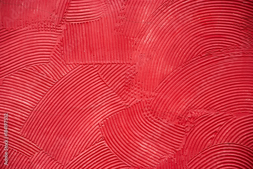 Red artistic handcraft circular pattern on cement wall