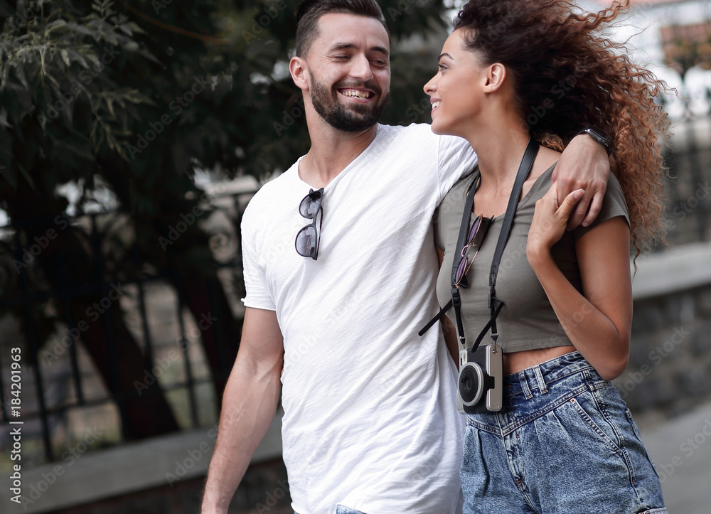 Cheerful young couple walking on urban street Cheerful young couple walking on urban street
