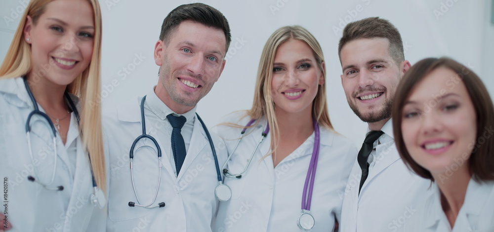 Smiling team of doctors at hospital making selfie. Smiling team of doctors at hospital making selfie.